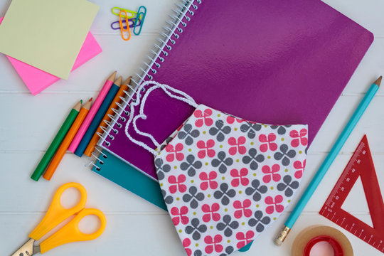 School supplies and cloth face mask. Back to school during covid-19 pandemic, new normal concept