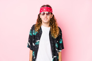 Young hippie caucasian man isolated laughs and closes eyes, feels relaxed and happy.