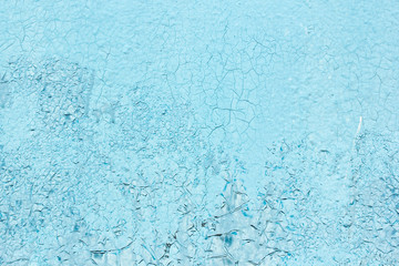 Fototapeta na wymiar Cracked texture of blue painted wall
