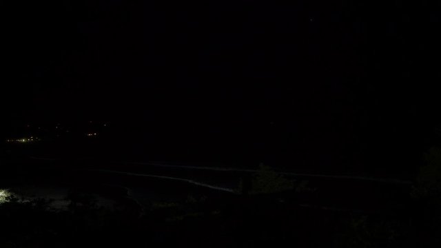 Thunderstorm lights on a tropical beach at night