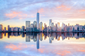 Manhattan Skyline with the One World Trade Center building at twilight - Powered by Adobe