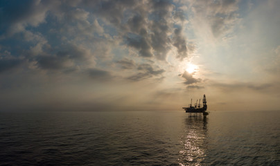 Aerial view offshore jack up rig at the offshore location during sunset