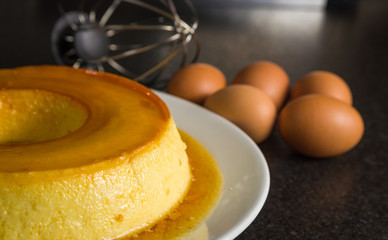 Traditional Brazilian dessert, milk pudding on dark background.