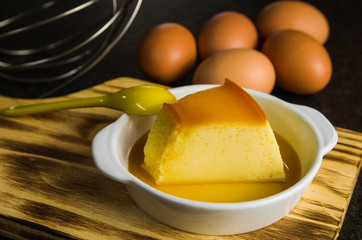 Fototapeta premium Traditional Brazilian dessert, milk pudding on dark background.