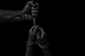 woman hands bound prisoner in room