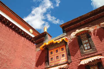 Fototapeta na wymiar Exterior of Sakya Monastery with the red wall and the windows in a sunny day, Tibet, China