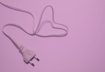 Heart concept of pink plug on a pink background.