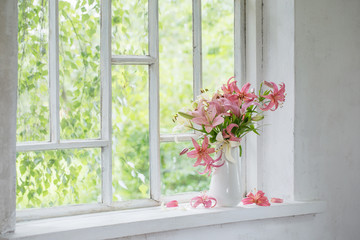 summer flowers in vase on white windowsill