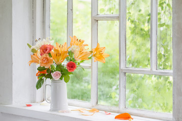 summer flowers in vase on background window with drops water