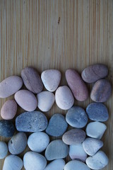 Pebble stones background concepts. wooden board background and light stones