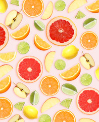 Tropical layout with fresh citrus fruits and apples on pale pink background, top view