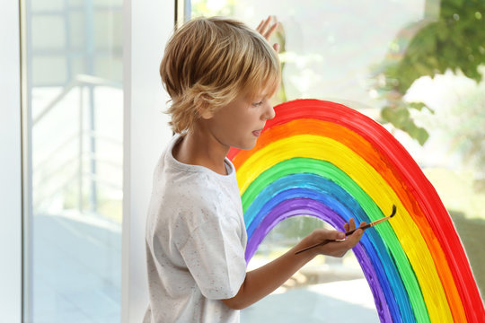 Little Boy Drawing Rainbow On Window. Stay At Home Concept