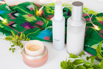 natural cosmetics collagen water ,toners serum therapy , eyes cream  health care for skin face with green scarf of lifestyle woman relax summer decoration flat lay style