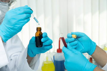 Researchers test blood samples in the laboratory. Researchers are inventing vaccines to treat COVID-19 virus.