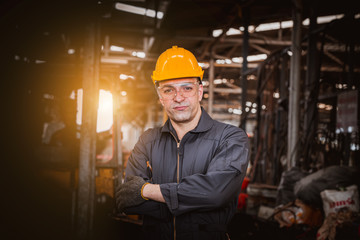 Portrait industry worker wearing safety uniform control operating computer controlled Lathe grinding machine working in industry factory.