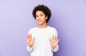 African american little boy isolated rejecting someone showing a gesture of disgust.