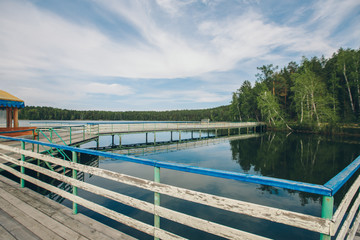 fishing bridge by the river. boat landing on the lake. water and transport