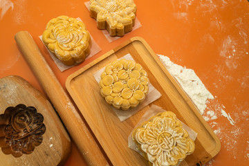 the wooden mold for mooncake, salted egg yolk, homemade cantonese moon cake pastry on baking tray before baking for traditional festival.