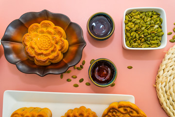 Flat lay mid autumn festival colorful food and drink on sweet pink background.