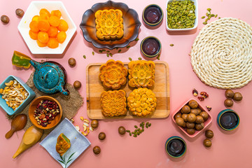 Flat lay mid autumn festival colorful food and drink on sweet pink background.