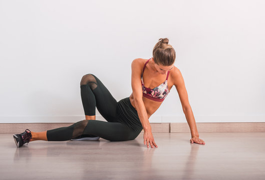 Slim woman doing pose on yoga mat
