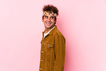 Young hipster man isolated Young man going to a festival looks aside smiling, cheerful and pleasant.