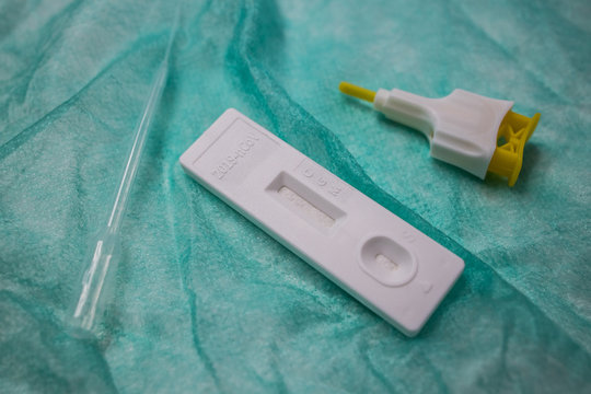 From above closeup of plastic pipette and lancet placed on table with tool for rapid COVID 19 blood test