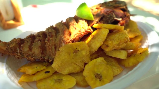 Close-up of one of the most delicious dishes in the Dominican Republic, Fried Fish with Fried Plantain