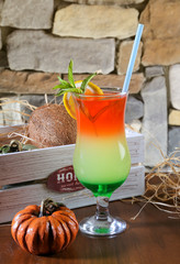 colorful cocktail for summer close up in front of stone wall
