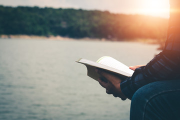 Men read book in the holiday in quiet nature, Concept reading a book.