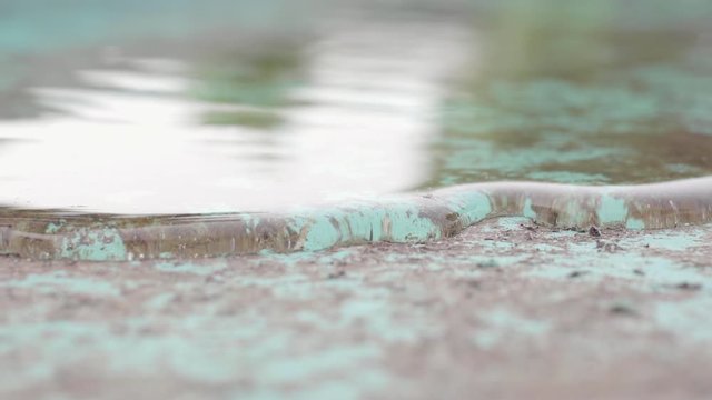 Macro shot of sheet of water running slowly, Laplace's law, example of surface tension of liquids