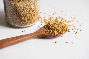 Close up bee pollen on a wooden spoon.