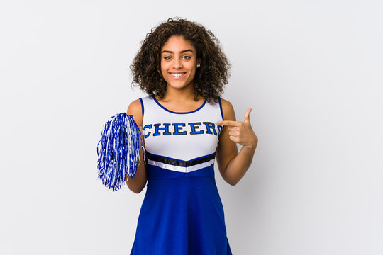 Young African American Cheerleader Woman Isolated Person Pointing By Hand To A Shirt Copy Space, Proud And Confident