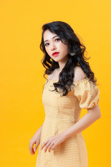 Studio shot of blithesome girl isolated on yellow background.