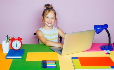 Schoolgirl studying homework during her lesson at home. Concept of kids education and reading.