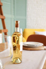 Bottle of wine on table in dining room