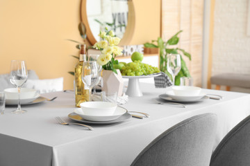 Fototapeta na wymiar Table set in modern dining room