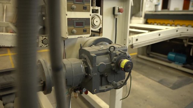 A slow dolly in of a tension controller machine.