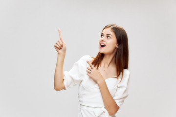 Woman shows a close finger up smile white dress Copy Space