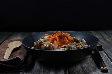Traditional grilled or roasted sliced pork seasoning with teriyaki sauce and topping with kimchi (local spicy mixed vegetable with chilly in Korea style). Famous rice menu in Asia restaurant. 