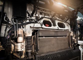 Front engine with open hood fixing and repairing big heavy semi truck.