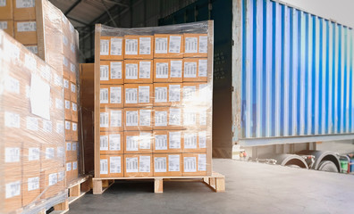 Logistics and transportation. Cargo freight, Shipment, Delivery service. Warehouse docks. Stacked package boxes on pallet waiting to load into cargo container truck.