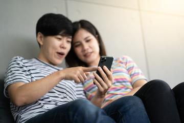 Fototapeta premium Happy girlfriends looking at a smartphone and having fun - 