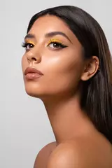 Closeup portrait of a beautiful girl with a bright sunny makeup. Beauty style shot. Clean skin and hair. Close up. © alesgon