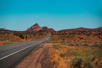 Mountain road, Barren scenery, Endless straight. Highway in USA.