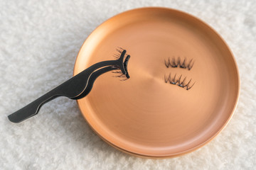 Magnetic fake eyelashes with magnet applicator. Fake lashes with mini magnets at beautician salon....