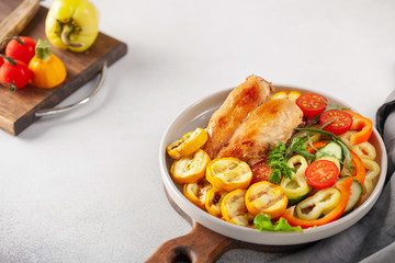 Diet lunch - chicken breast with zucchini grill and fresh vegetables. Top view