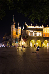 Obraz premium Krakow, Poland - July 20, 2017: In Summer Evening People Walk On The Main Square In Royal City Krakow In Poland.