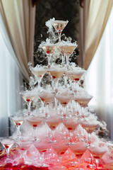 Champagne glass pyramid.pyramid of glasses of wine, champagne, tower of champagne's glass in wedding reception party