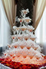 Champagne pyramid with waitress on event, party or wedding banquet reception